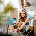 Eine junge Frau richtet ihre erste eigene Wohnung ein.
